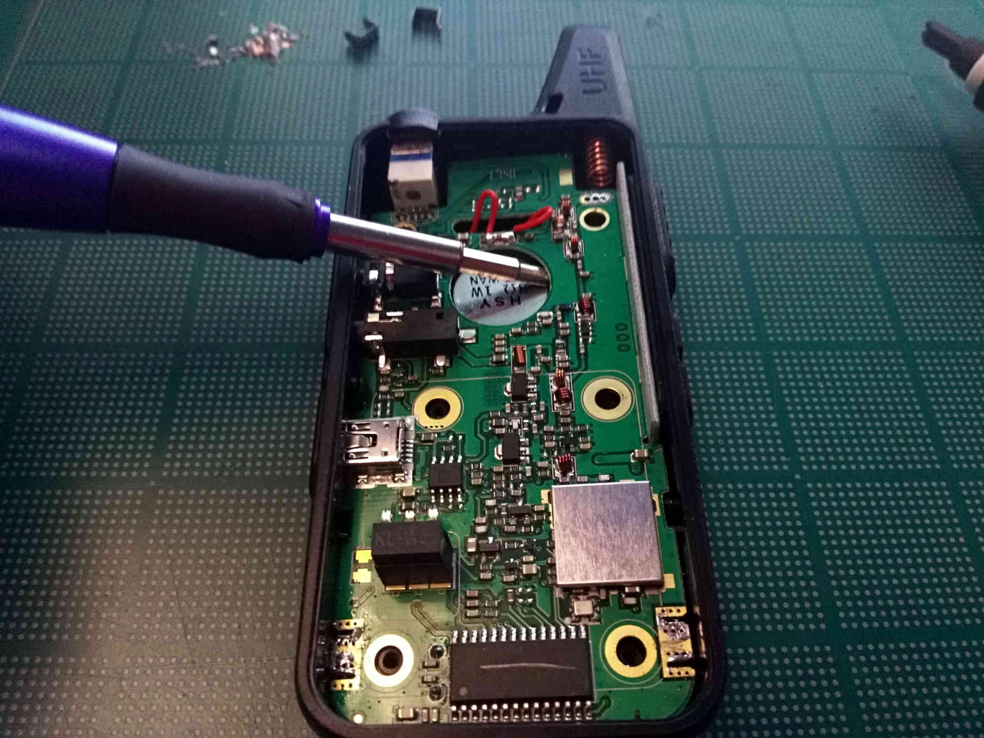 PCB pried away from casing using a screwdriver